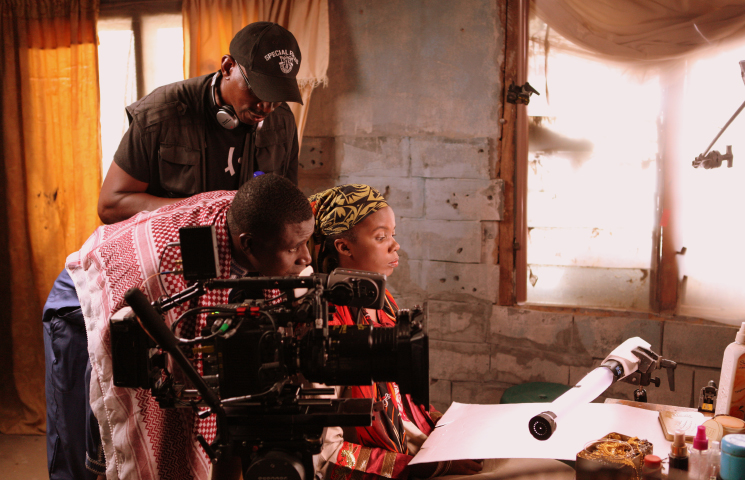 Director Desmond Ovbiagele with actors on the set of The Milkmaid in Jalingo, Taraba State, Nigeria.